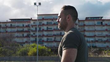 Man Walks Lonely In The Field Near The Buildings video