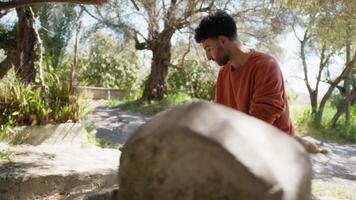 Boy Fills Watering From Fountain Can For Plants In The Countryside Of Calabria video