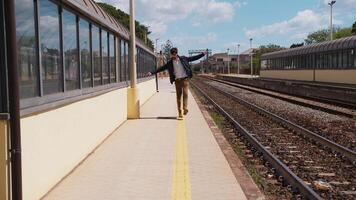 Young Boy Walks On The Yellow Line Delimiting The Tracks In The Station video