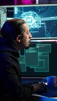 Vertical Hacker using AI technology to target vulnerable unpatched connections to steal data. Cybercriminal using artificial intelligence to compromise digital devices and gain illicit info, camera A video