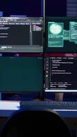 Vertical Code running on monitors in empty apartment used by hacker stealing state secrets from another countries. Malicious scripts on PC screens used by spy infiltrating governments video