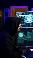 Vertical Hacker running artificial intelligence spyware software designed to gather information from users computers without their knowledge. Scammer commits fraud using AI, camera B video