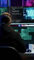 Vertical Rogue IT engineer uses AI deep learning to develop zero day exploit undetectable by antivirus. Hacker uses artificial intelligence computerized model to build script doing data mining, camera A video