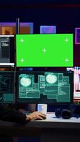Vertical Spy using green screen PC in secret hideout to steal valuable data by hacking, getting attacks rejected by security. Hacker using mockup monitor seeing access denied error message, camera B video