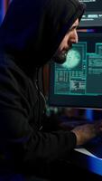Vertical Hacker using PC to steal data, targeting unpatched security systems using malware. Scammer using computer to compromise digital devices, writing rogue script attacking firewalls, camera A video