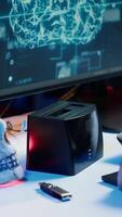 Vertical Hacker uploading script on SSD that can launch DDoS attacks on any website. Cybercriminal writing program that can crash servers, downloading it on storage drive, camera A video