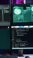 Vertical Code running on monitors in empty apartment used by hacker stealing state secrets from another countries. Malicious scripts on PC screens used by spy infiltrating governments video