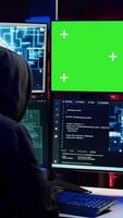 Vertical Hacker using AI machine learning and isolated screen computer to produce malware corrupting data. Scammer working on chroma key PC using artificial intelligence tech, infecting systems, camera B video