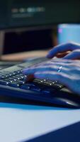 Vertical Cybercriminal illegally breaching security systems while hiding in secret HQ, close up shot. Scammer breaking down security systems firewalls using rogue scripts to steal sensitive data, camera A video