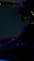 Vertical Hacker taking laptop out of suitcase, prepared to launch DDoS attack. Cybercriminal entering apartment, getting notebook from bag, starting work on malware script, close up, camera B video