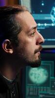 Vertical Hacker using AI machine learning on computer to produce malware corrupting data. Scammer working on PC using artificial intelligence tech, infecting systems, close up shot, camera A video