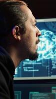 Vertical Hacker using AI machine learning to find unpatched connections and steal data. Close up shot of scammer using artificial intelligence to compromise digital devices and illegally gaining info, camera A video