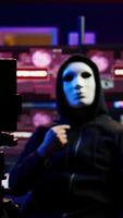 Vertical Focus on camera on phone on tripod used by hacker concealing identity filming ransom in hidden base. Close up of smartphone used by cybercriminal with mask to record blackmail footage, camera B video