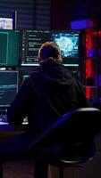 Vertical Hacker in hideout interrupted by police sirens from writing malware code on computer, running to escape before getting caught. Criminal den found by anti hacking law enforcement, camera B video