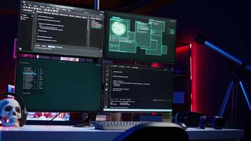 Close up shot of software interface on computer screens showing developer code running in empty criminals den. Hacking malware programming script on monitors in underground base video