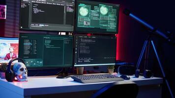 Close up of code running on computer displays in empty apartment used by hacker stealing secrets. Illegal scripts on PC screens used by spy infiltrating governments, handheld camera shot video