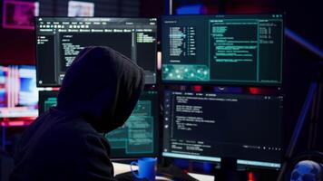 Hacker using PC to steal data, targeting unpatched security systems using malware. Scammer using computer to compromise digital devices, writing rogue script attacking firewalls, camera A video