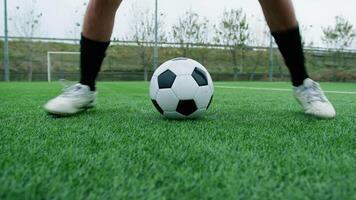 Feet Of A Teeneger Does Tricks With The Soccer Ball In The Field video