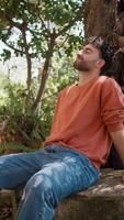 Young Farmer Resting Tired Admiring Nature Sitting Near Tree In The Countryside video