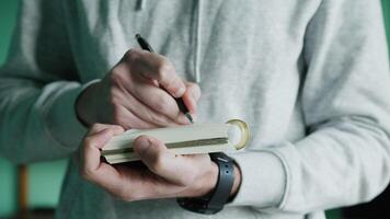 Man Writes In Notebook In A Room video