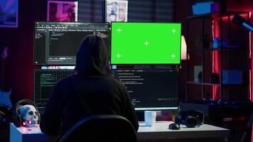 Cybercriminal uploading USB flash drive containing stolen information into green screen computer. Scammer inserting storage device into chroma key PC with data obtained from security breach, camera A video