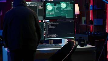 Hacker arriving in secret base with laptop, ready to start programming viruses. Scammer in criminal den opening notebook to exploit network servers and bypass security measures, camera A video
