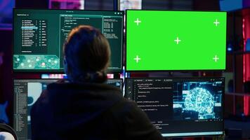 Hacker uses green screen PC and AI deep learning to develop zero day exploit undetectable by antivirus. Scammer uses artificial intelligence and mockup computer to build data mining script, camera A video