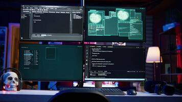 Close up of desk in criminals den and hacking software interface on PC used for stealing data and blackmailing victims. Technology in apartment used for deploying DDOS attacks scripts video