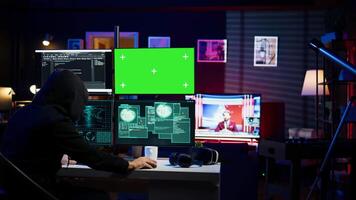 Spy using green screen PC in secret hideout to steal valuable data by hacking, getting attacks rejected by security. Hacker using mockup monitor seeing access denied error message, camera B video