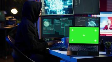 Isolated screen laptop used by cybercriminal in underground hideout to write lines of code and malware scripts. Mockup notebook used by evil programmer in hidden bunker, close up shot, camera A video