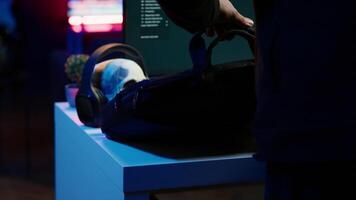 Hacker taking laptop out of suitcase, prepared to launch DDoS attack. Cybercriminal entering apartment, getting notebook from bag, starting work on malware script, close up, camera A video