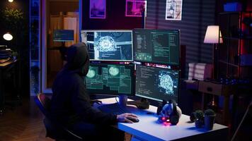 Evil cybercriminal using AI deep learning to produce virus corrupting data. Rogue programmer working on PC using artificial intelligence technology, penetrating security systems, camera B video