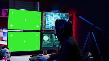 Cybercriminal using AI deep learning to produce virus corrupting data on mockup PC. Rogue developer working on isolated screen computer using artificial intelligence, penetrating security, camera B video