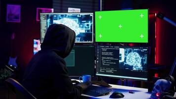Hacker using green screen PC and AI to find unpatched connections and steal data. Scammer using artificial intelligence and chroma key computer to compromise digital devices, camera B video