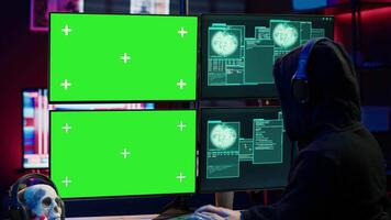 Hacker receiving access denied error message on chroma key monitors while doing corporate espionage. Scammer failing to steal information on competitor products using green screen PC, camera A video