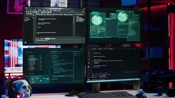 Lines of code running on computer monitors in empty room used by cybercriminal stealing sensitive information. Dangerous scripts on PC used for threatening network systems, panning shot video