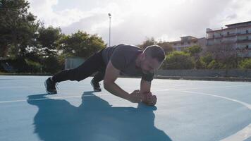 Man Does Abdominal Bridge Exercises Outside video