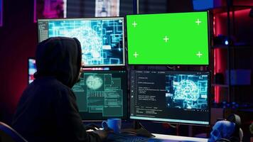 Hacker using AI machine learning and isolated screen computer to produce malware corrupting data. Scammer working on chroma key PC using artificial intelligence tech, infecting systems, camera A video