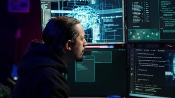 Hacker using artificial intelligence technology to write spyware software able to gather information from users. Scammer in apartment doing fraud using AI, close up, camera A video