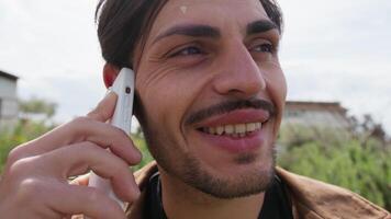 Boy With Mustache Talking On The Phone Smiling Outside In The Park video