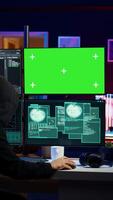 Vertical Cybercriminal hacking using green screen PC and getting critical error while trying to steal credit card information. Hacker runs code on mockup computer display, failing to breach firewall, camera B video