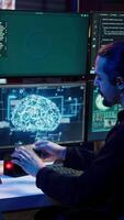 Vertical Hacker uploading script on SSD that can launch DDoS attacks on any website. Cybercriminal writing program that can crash servers, downloading it on storage drive, camera B video