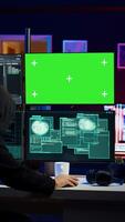 Vertical Rogue programmer using green screen PC to hack firewalls, getting attacks rejected by cybersecurity. Scammer using mockup monitor seeing access denied error message while committing fraud, camera B video