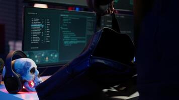 Hacker arriving in underground HQ with laptop in suitcase, ready to start coding malware. Cybercriminal opening notebook to exploit network backdoors and bypass security measures, close up, camera B video