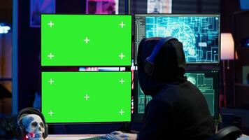 Cybercriminal using AI deep learning to produce virus corrupting data on mockup PC. Rogue developer working on isolated screen computer using artificial intelligence, penetrating security, camera A video