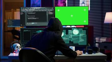 Rogue programmer using green screen PC to hack firewalls, getting attacks rejected by cybersecurity. Scammer using mockup monitor seeing access denied error message while committing fraud, camera A video