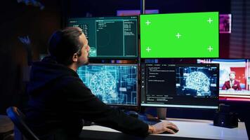 Hacker uses green screen PC and AI deep learning to develop zero day exploit undetectable by antivirus. Scammer uses artificial intelligence and mockup computer to build data mining script, camera B video