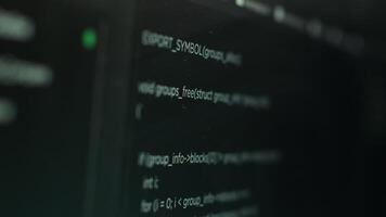 Extreme close up shot of hacking code running on computer system monitors attacking firewalls. Programming scripts shown on PC screen used by cyber criminals to breach security video