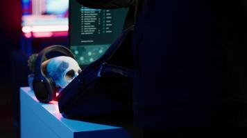 Hacker arriving in underground HQ with laptop in suitcase, ready to start coding malware. Cybercriminal opening notebook to exploit network backdoors and bypass security measures, close up, camera A video