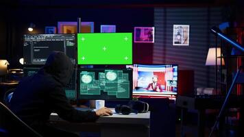 Cybercriminal hacking using green screen PC and getting critical error while trying to steal credit card information. Hacker runs code on mockup computer display, failing to breach firewall, camera B video